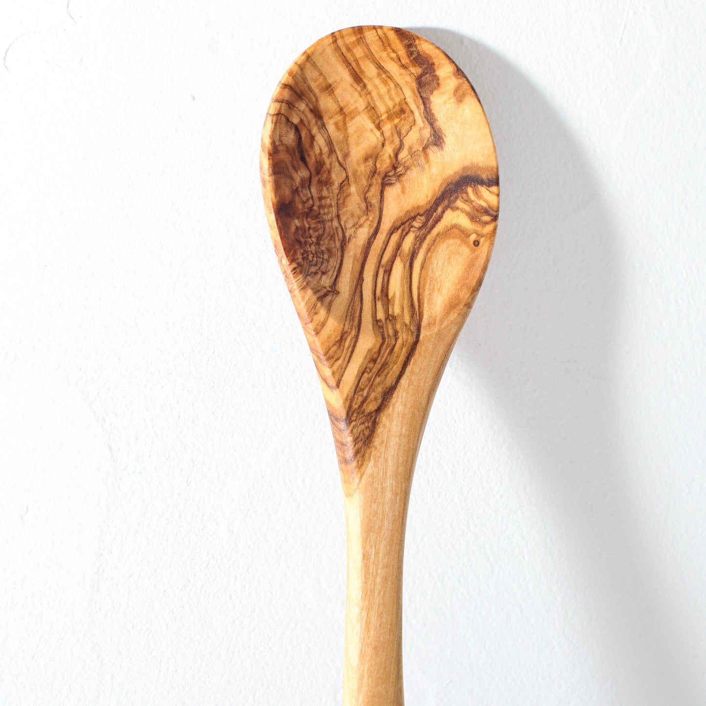 a detail shot of an olive wood spoon wood grain