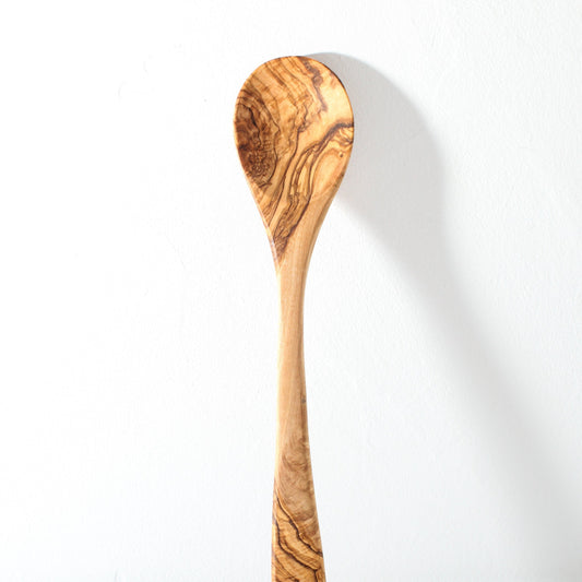 A kitchen spoon carved from olive wood