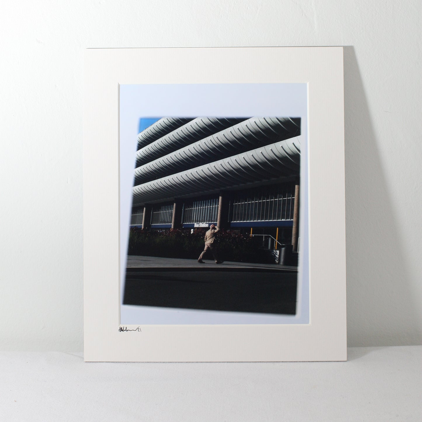 a mounted image of the outside of preston bus station  with a person walking into it
