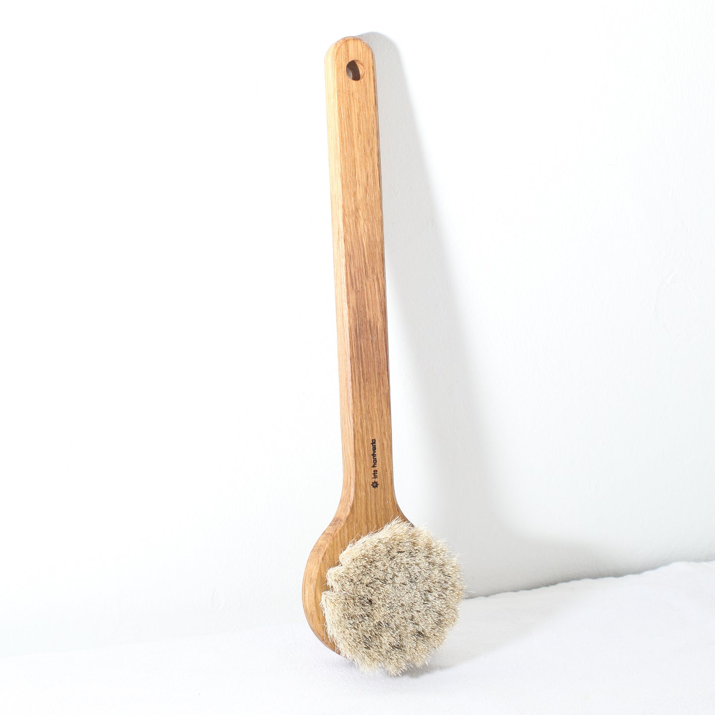 A wooden bath brush with horse hair bristles